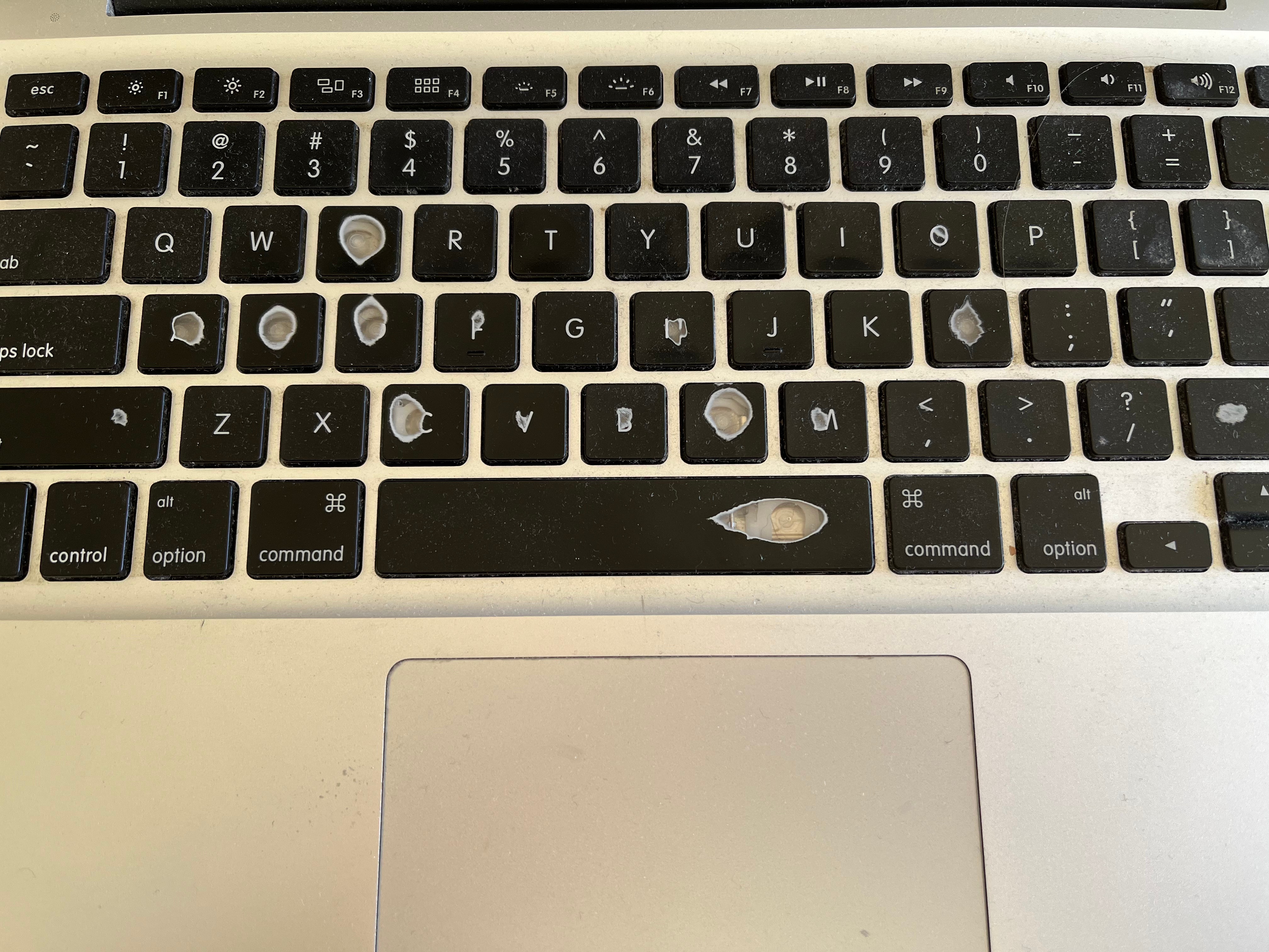 Photo of a very worn and overused Macbook keyboard.