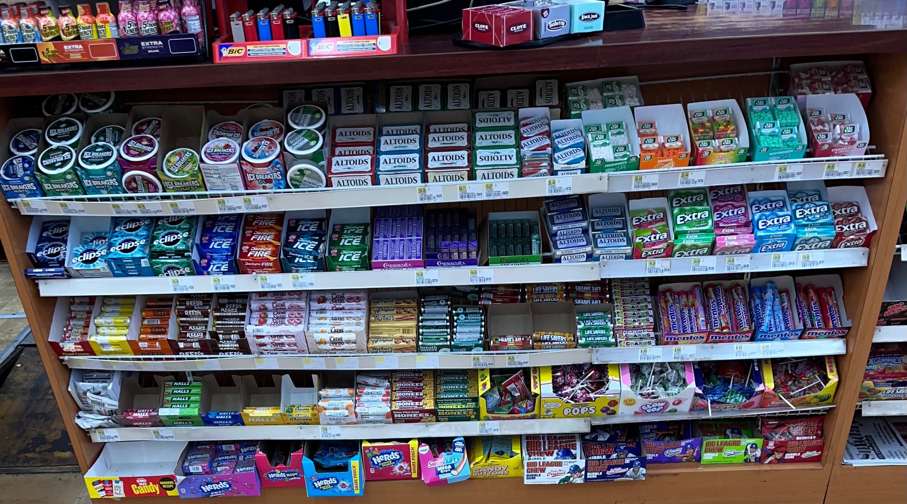 Picture of a store display of chewing gums, mints and candy.