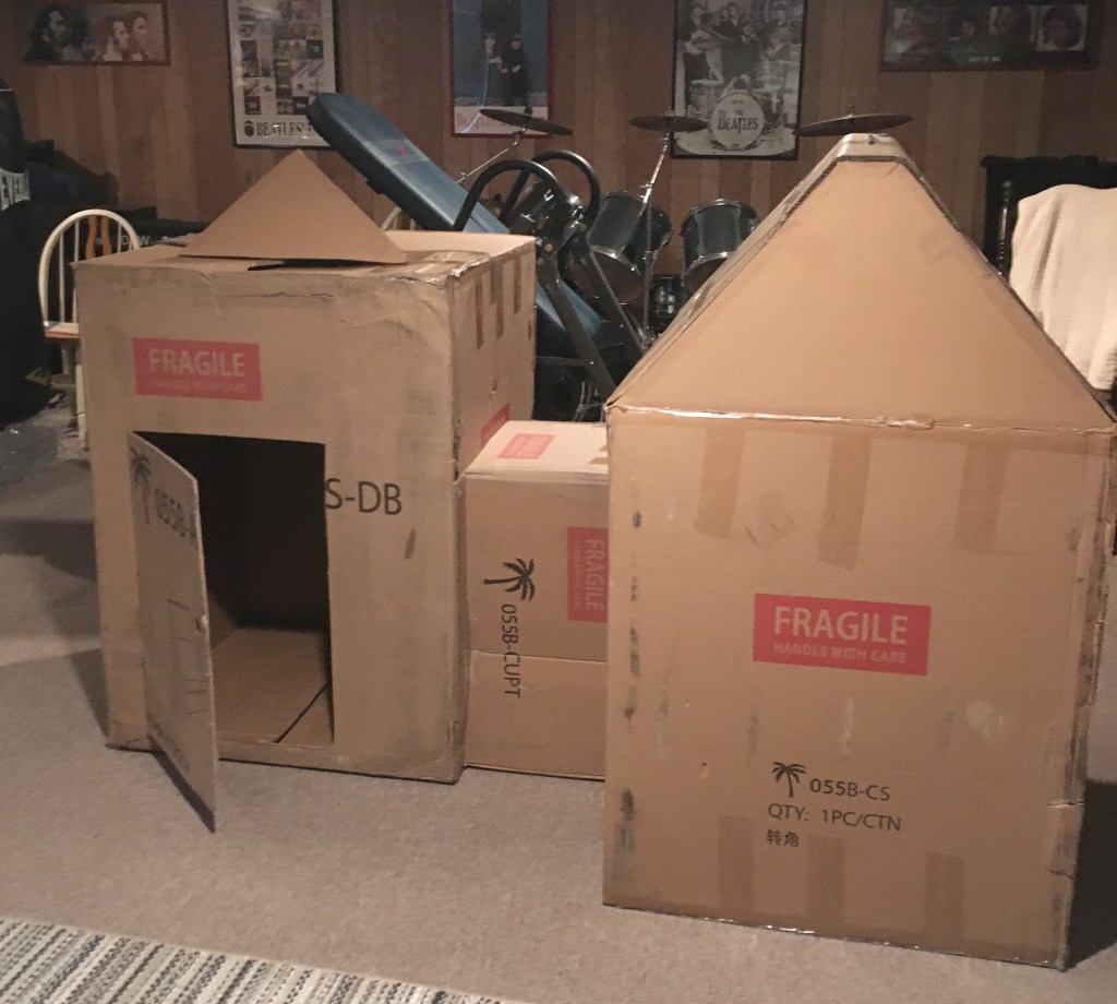 Photo of a playhouse or fort made out of cardboard boxes.