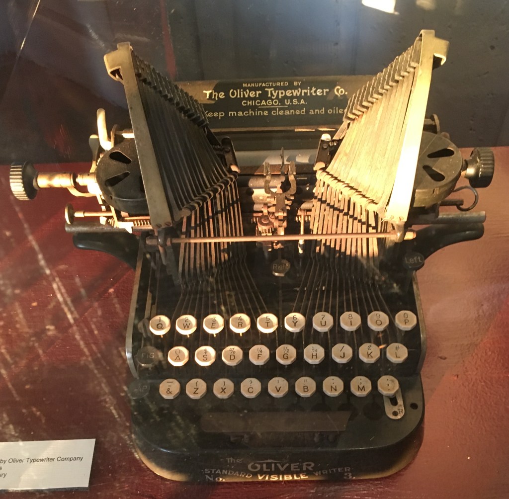 Photo of an antique typewriter that's part of a museum display.