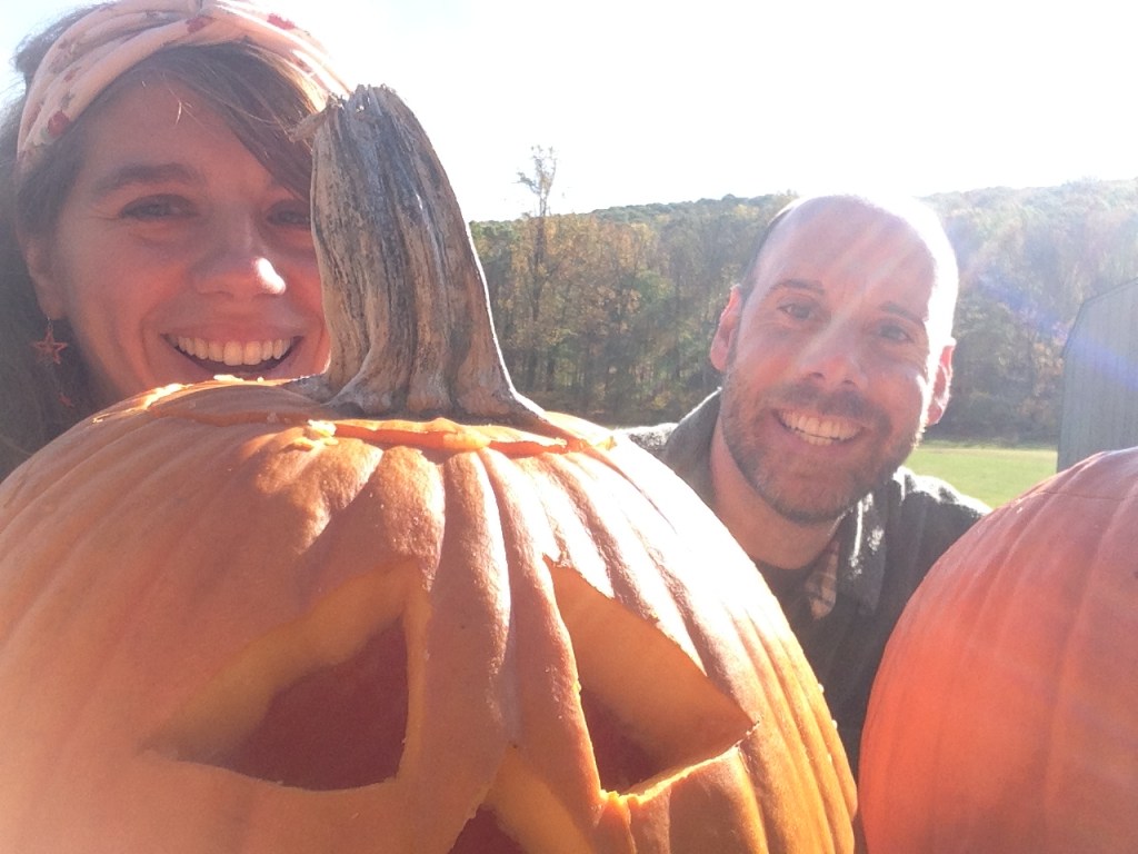 Photo of the author and her boyfriend with come carved pumpkins.