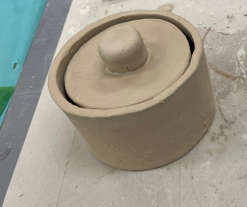 Photo of an unfinished clay jar.